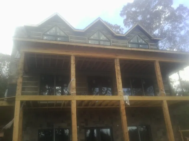 Dormers and porch framing on a large log home under construction in Hillsboro